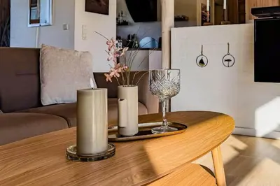 a coffee table with two candles and a wine glass at LK537-Lokken-Mievej-20 in Løkken