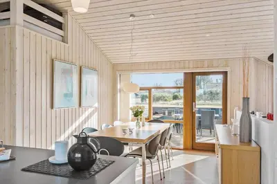 a kitchen and dining room with a table and chairs at LK537-Lokken-Mievej-20 in Løkken