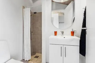 a white bathroom with a sink and a mirror at LK537-Lokken-Mievej-20 in Løkken