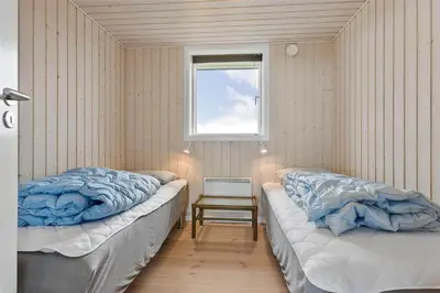 two beds in a room with a window at LK1280-Lokken-Kettrup-Bjerge-Vej-98 in Løkken