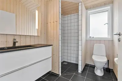 a bathroom with a toilet and a sink at LK1280-Lokken-Kettrup-Bjerge-Vej-98 in Løkken