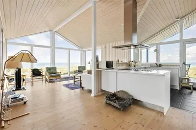 a kitchen and living room with a lot of windows at LK1280-Lokken-Kettrup-Bjerge-Vej-98 in Løkken