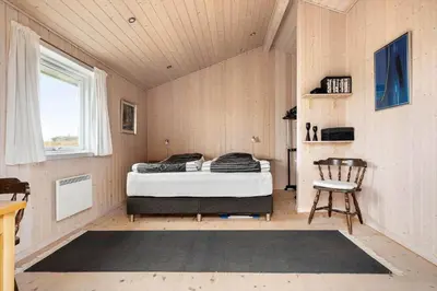 a bedroom with a bed in a room with a window at LK784-Lokken-Sinnesvej-7 in Løkken