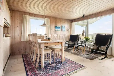 a dining room with a table and chairs at LK784-Lokken-Sinnesvej-7 in Løkken