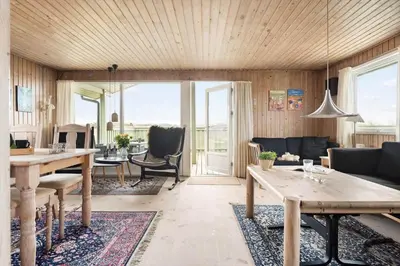 a living room with a table and a couch at LK784-Lokken-Sinnesvej-7 in Løkken