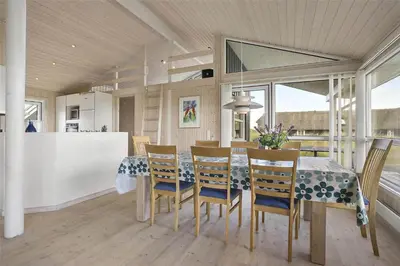 a kitchen and dining room with a table and chairs at LK1179-Lokken-Normasvej-6 in Løkken