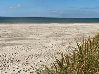 a sandy beach with the ocean in the background at LK2065-Lokken-Rikkesvej-5 in Løkken