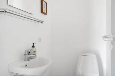 a white bathroom with a sink and a toilet at LK2065-Lokken-Rikkesvej-5 in Løkken