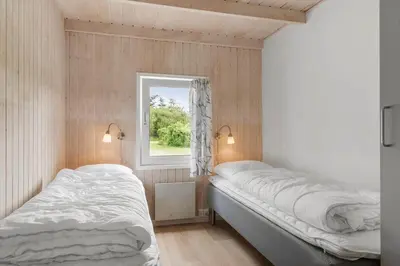 a bedroom with two beds and a window at LK2084-Lokken-Margrethevej-76 in Løkken