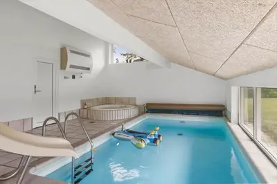 a swimming pool with a toy in the middle of a house at LK2084-Lokken-Margrethevej-76 in Løkken