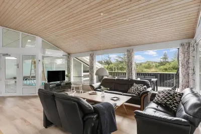 a living room with leather furniture and a wooden ceiling at LK2084-Lokken-Margrethevej-76 in Løkken