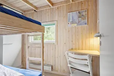 a small bedroom with a bunk bed and a desk at LK626-Lokken-Magdalenevej-40 in Løkken