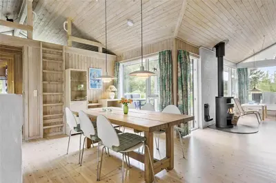 a dining room with a wooden table and chairs at LK626-Lokken-Magdalenevej-40 in Løkken