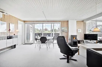a living room with a table and chairs at LK1779-Lokken-Lydiavej-2 in Løkken