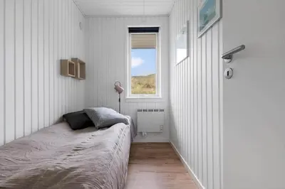 a bedroom with a bed and a window at LK2033-Lokken-Madsinesvej-13 in Løkken