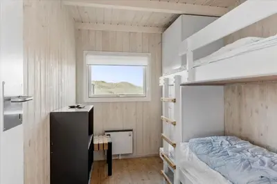 a bedroom with a bunk bed and a window at LK1847-Lokken-Ornegaardsvej-17 in Løkken
