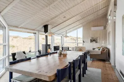 a dining room with a large wooden table and chairs at LK1847-Lokken-Ornegaardsvej-17 in Løkken