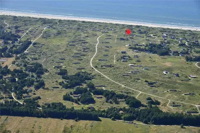 a red balloon flying over a field next to the ocean at LK1272-Lokken-Ruthsvej-17 in Løkken