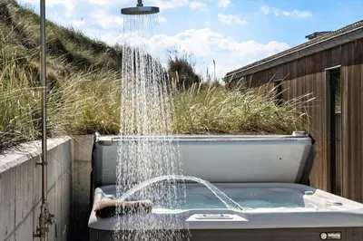 a bath tub with a shower with water coming out at LK1272-Lokken-Ruthsvej-17 in Løkken