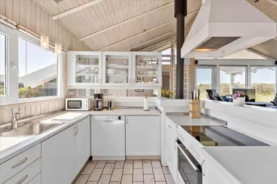 a kitchen with white cabinets and a sink at LK431-Lokken-Kettrup-Bjerge-Vej-62 in Løkken