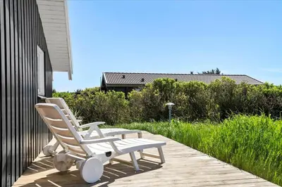 two white chairs sitting on a wooden deck at LK431-Lokken-Kettrup-Bjerge-Vej-62 in Løkken