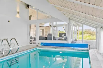 a swimming pool in a house with a patio at LK431-Lokken-Kettrup-Bjerge-Vej-62 in Løkken
