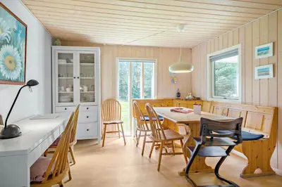 a kitchen and dining room with a table and chairs at LK1354-Lokken-Madsinesvej-4 in Løkken