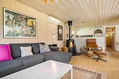a living room with a couch and a table at LK1354-Lokken-Madsinesvej-4 in Løkken
