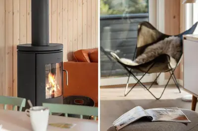 a living room with a fireplace and a chair and a newspaper at LK2112-Lokken-Kettrup-Bjerge-Vej-64 in Løkken