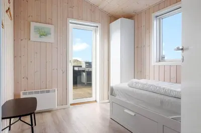 a bedroom with a bed and a window and a desk at LK2112-Lokken-Kettrup-Bjerge-Vej-64 in Løkken