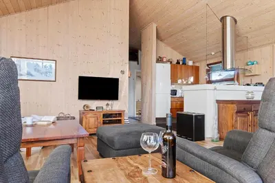 a living room with a wine glass on a table at LK933-Lokken-Olgavej-34 in Løkken