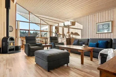 a living room with a couch and a table at LK933-Lokken-Olgavej-34 in Løkken