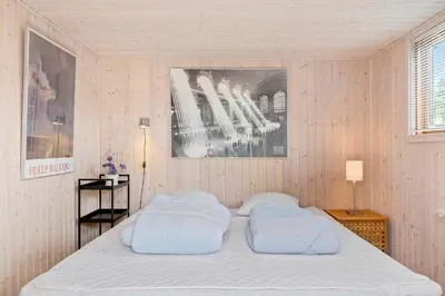 a bedroom with a bed with two pillows on it at LK1840-Lokken-Olgavej-32 in Løkken