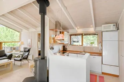 a kitchen and living room with a wood stove at LK1840-Lokken-Olgavej-32 in Løkken