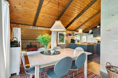 a kitchen and dining room with a table and chairs at LK1709-Lokken-Ruthsvej-12 in Løkken