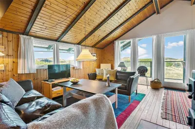 a living room with a couch and a table at LK1709-Lokken-Ruthsvej-12 in Løkken