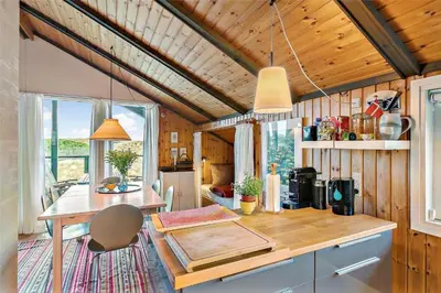 a kitchen with a table and a dining room at LK1709-Lokken-Ruthsvej-12 in Løkken