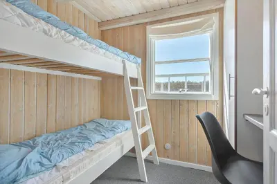 a bunk bed in a room with a ladder at LK855-Lokken-Monasvej-7 in Løkken