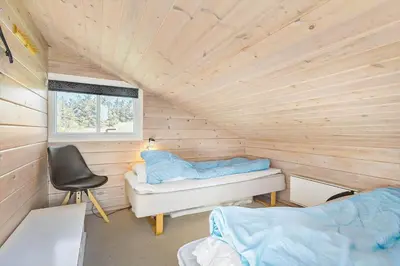 a room with a bed and a desk in a wooden room at LK855-Lokken-Monasvej-7 in Løkken