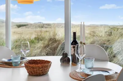 a table with wine glasses and wine bottles on it at LK326-Lokken-Monasvej-31 in Løkken