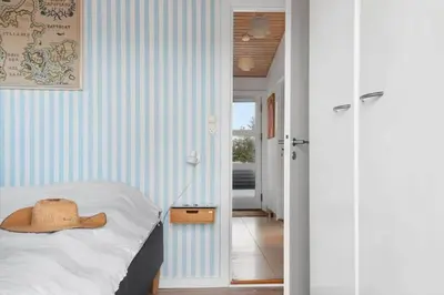 a bedroom with a bed with a hat on it at LK326-Lokken-Monasvej-31 in Løkken