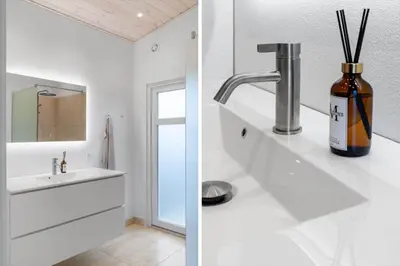a bathroom with a sink and a bottle on a counter at LK326-Lokken-Monasvej-31 in Løkken