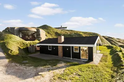 a house on top of a hill with grass at LK1958-Lokken-Kettrup-Bjerge-Vej-78-A in Løkken
