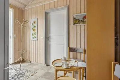 a room with a table and a white door at BL1220-Blokhus-Peter-Andersensvej-21 in Blokhus