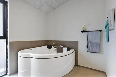 a bathroom with a white tub and a sink at BL1557-Saltum-Tolhoj-52 in Saltum