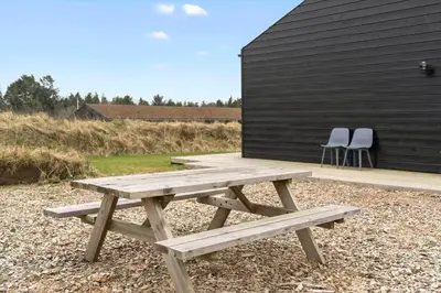 a wooden picnic table in front of a building at BL1557-Saltum-Tolhoj-52 in Saltum