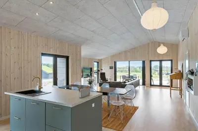 a kitchen and living room with a table and chairs at BL1557-Saltum-Tolhoj-52 in Saltum