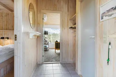 a hallway with a door leading to a bedroom at LK850-Lokken-Jorginesvej-8 in Løkken