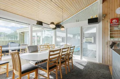 a dining room with a white table and chairs at LK850-Lokken-Jorginesvej-8 in Løkken