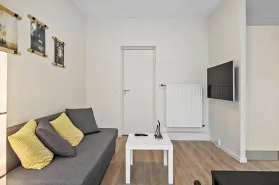 a living room with a couch and a table at BL1583-Blokhus-Strandvejen-14-Lejl-12 in Blokhus